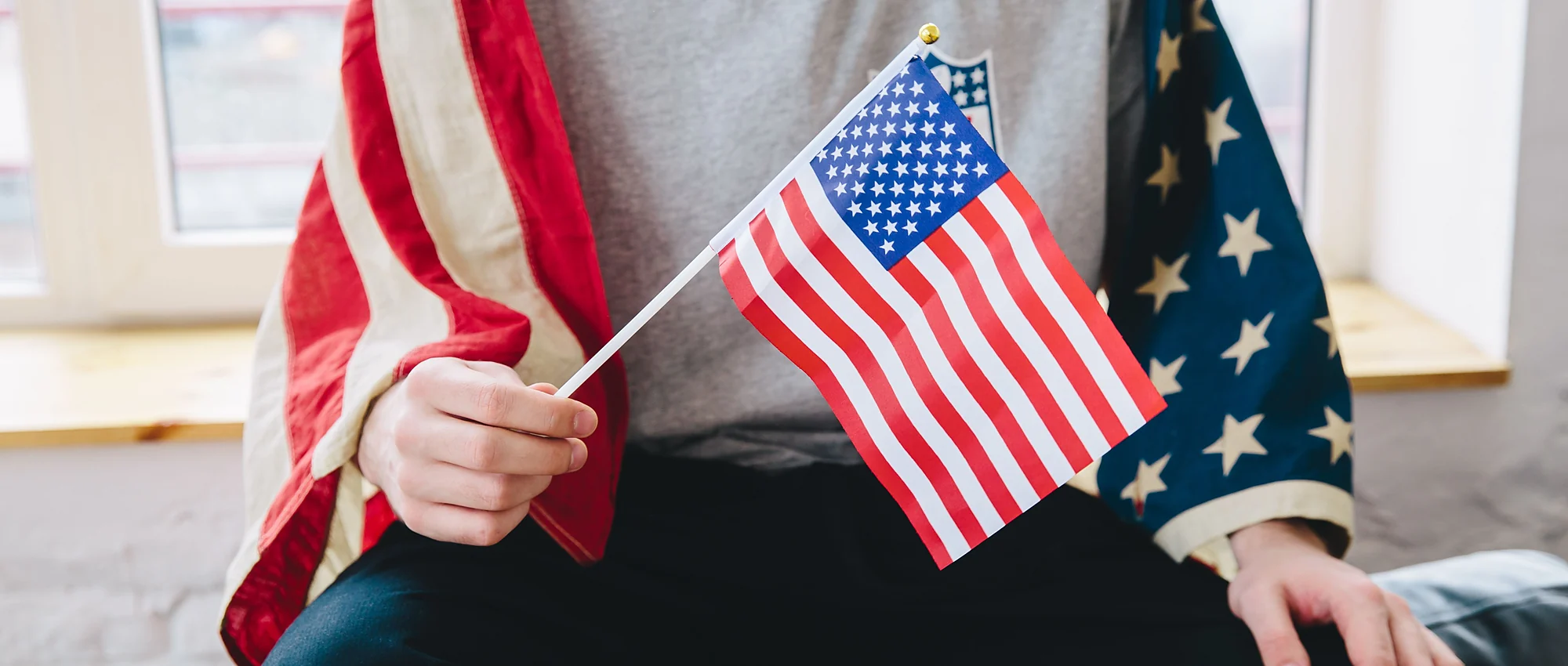 Una persona sosteniendo una banderita de Estados Unidos